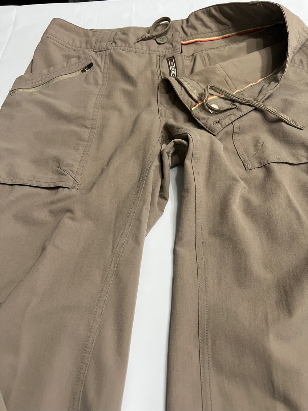 REI Cargo Pants in Taupe. UPF 60. Adjustable at the bottom of legs.